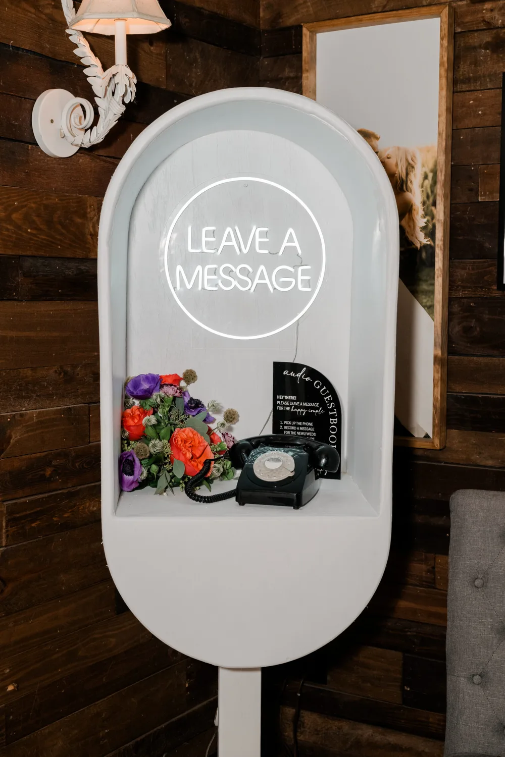 Audio guest book phone booth with a Leave a Message neon sign