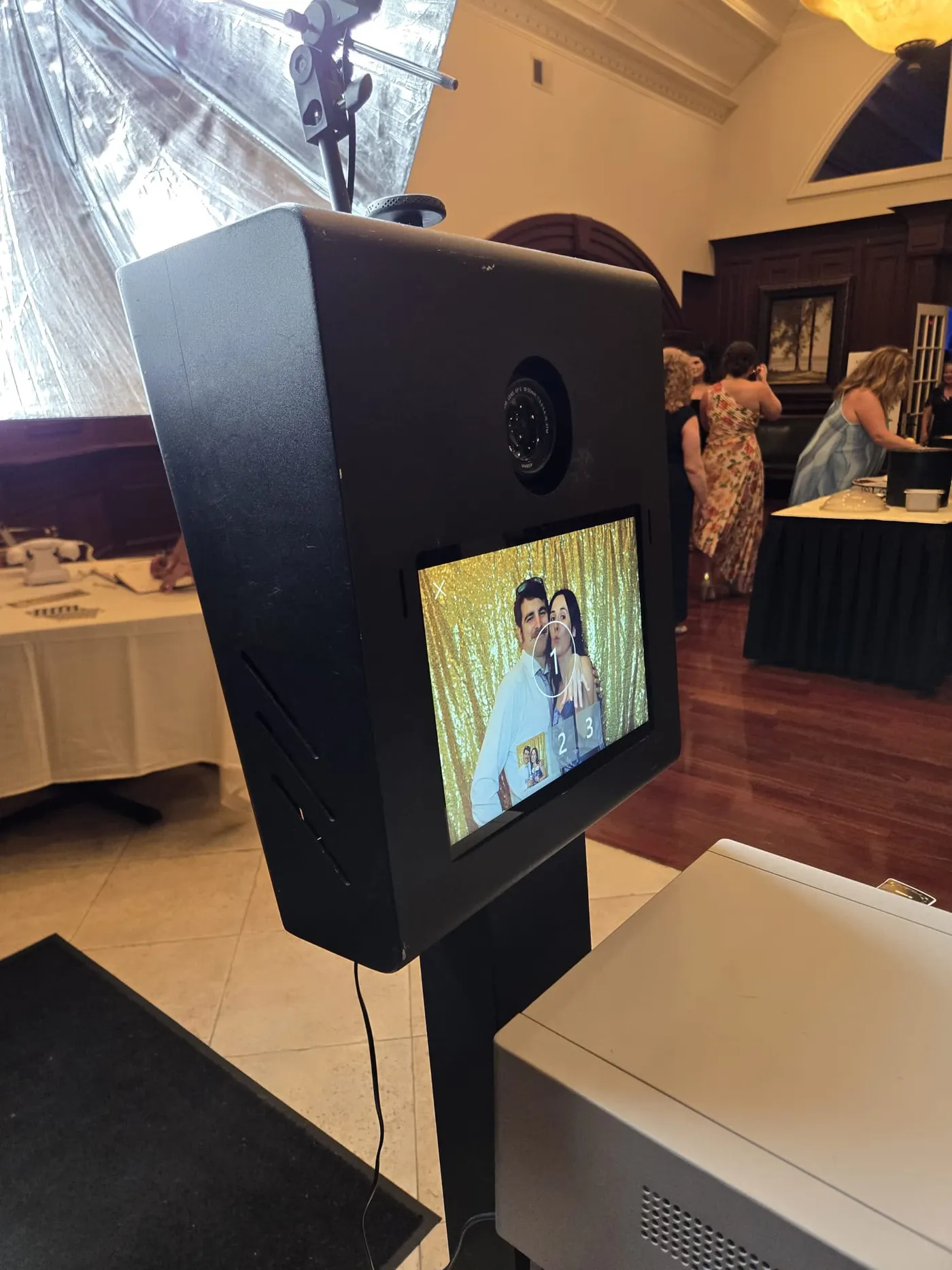 Photo booth screen showing a couple's photo at a wedding