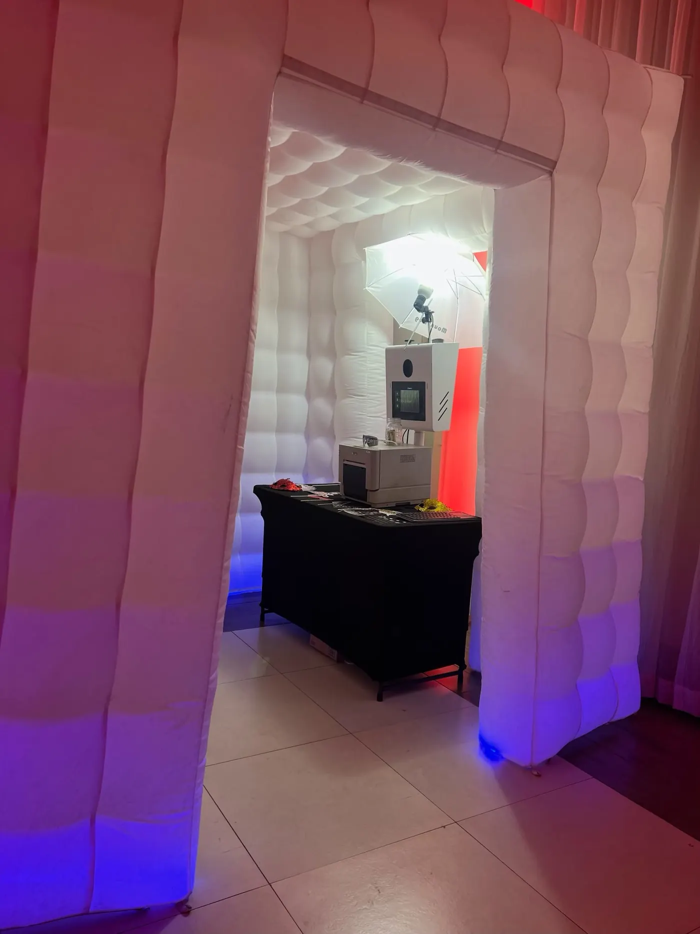 Glowing white inflatable photo booth enclosure